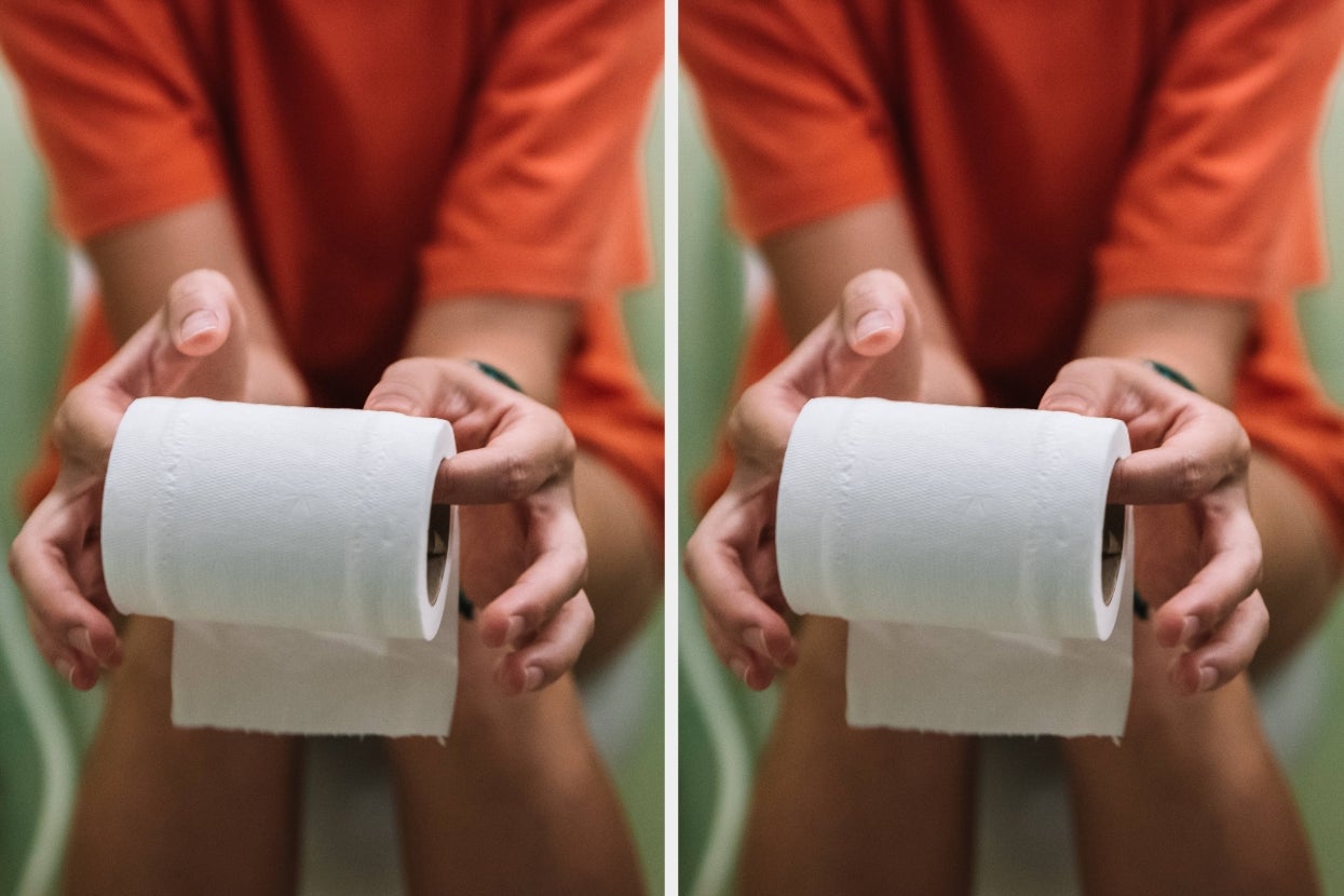 Person sitting, seen holding and unrolling toilet paper, wearing casual clothing. Image emphasizes the accessibility and necessity of daily hygiene items