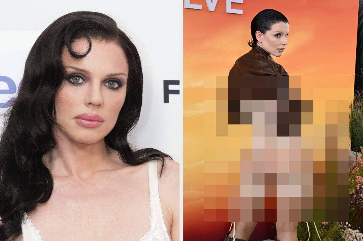 Person posing on the red carpet in a unique, revealing outfit with slicked-back hair