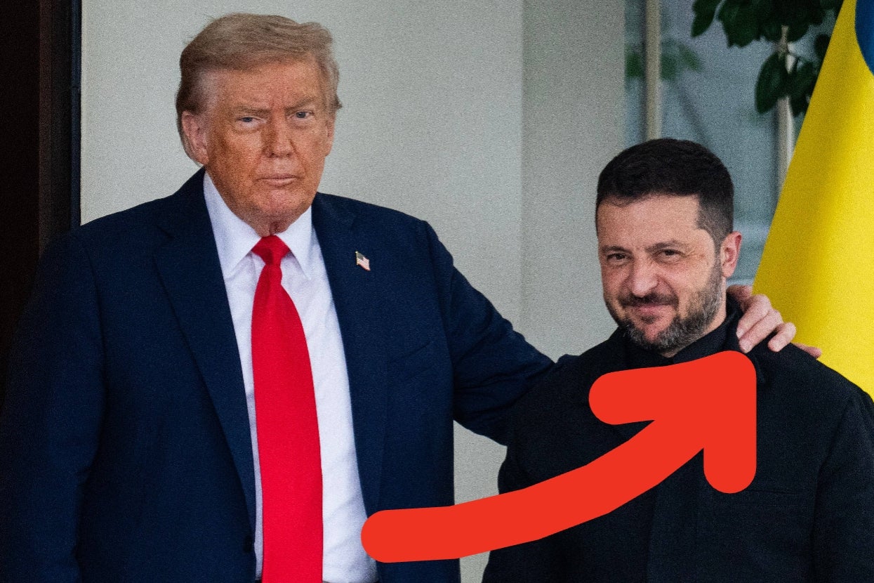 Two men stand together, one in a suit with a red tie, the other in casual attire. A large red arrow points to the man in casual attire