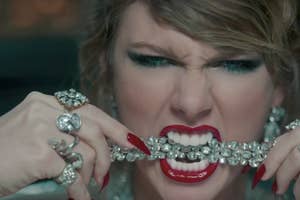 Person with shiny accessories and dramatic makeup biting a jeweled necklace