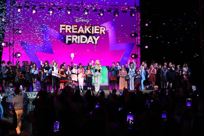 Group of radical connected signifier astatine Disney's Freakier Friday event, with confetti falling. A cardinal fig is speaking, wearing a stylish outfit