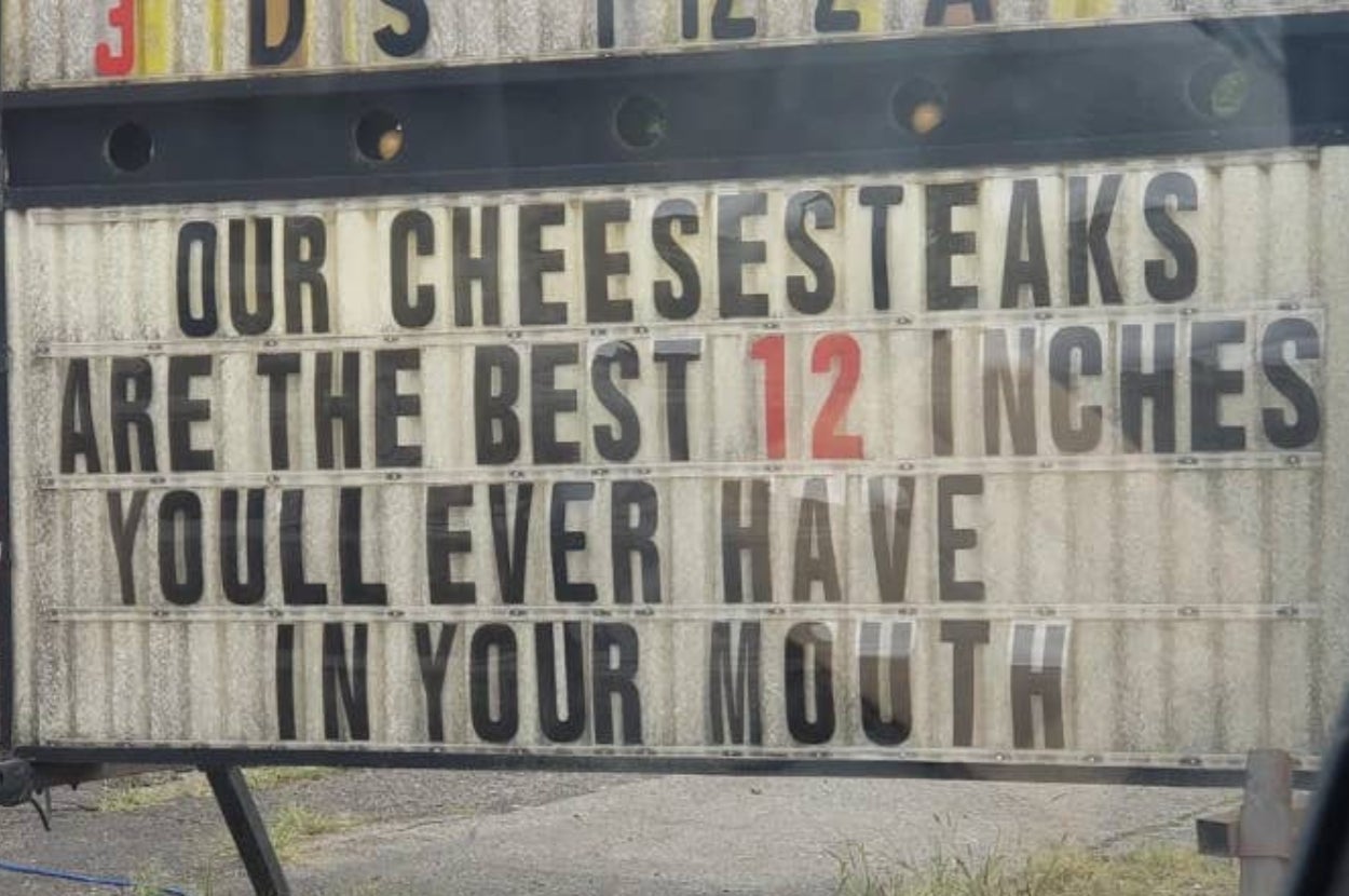 Sign reads: "Our cheesesteaks are the best 12 inches you'll ever have in your mouth."