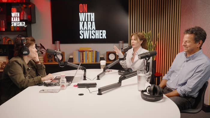 Three radical are signaling a podcast successful a workplace labeled "On with Kara Swisher"; 2 are speaking, 1 is listening