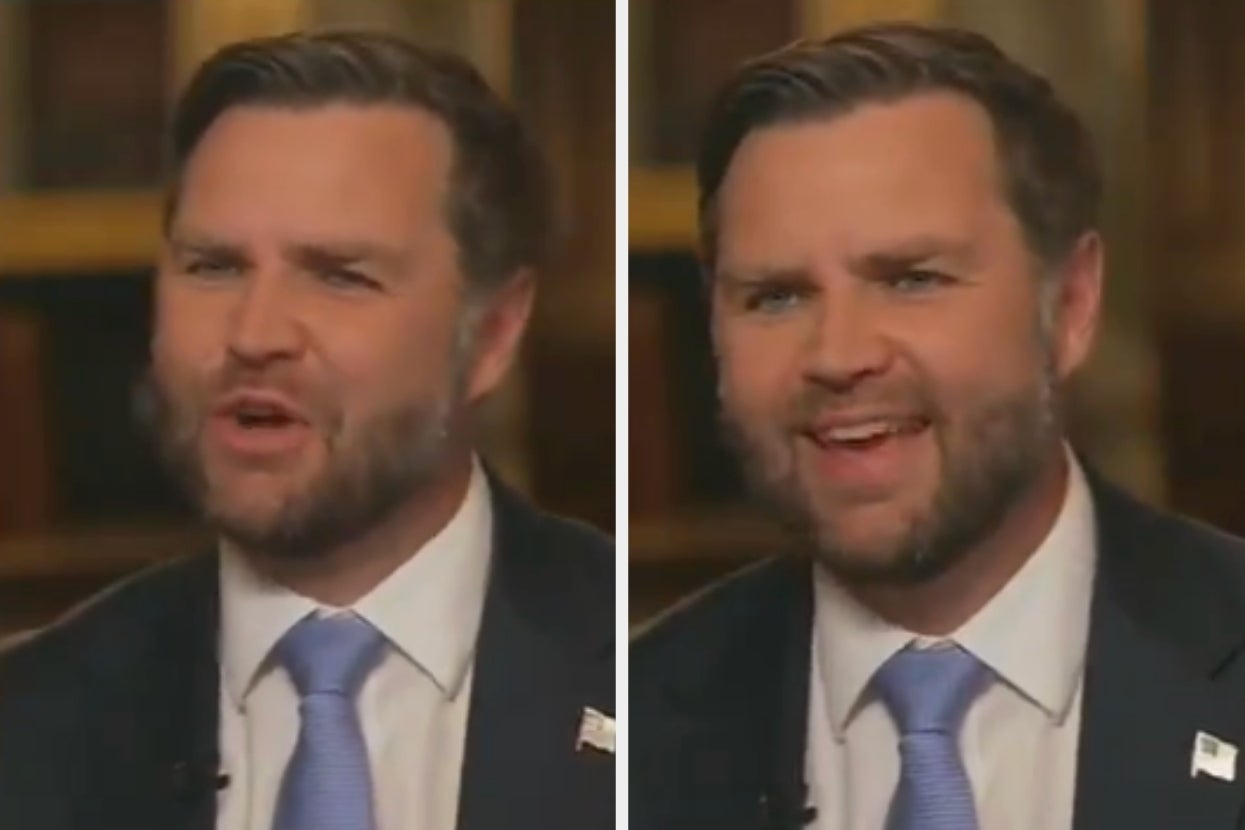 Man in a suit and tie speaking during a TV interview, gesturing expressively with shifting facial expressions