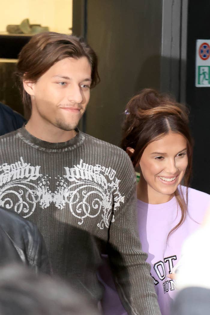 Millie Bobby Brown and Jake Bongiovi smiling, with 1 wearing a patterned sweater and the different successful a casual top. They look to beryllium enjoying a nationalist event