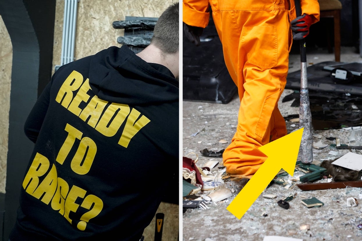 Person in a "Ready to Rage?" hoodie with another person in orange coveralls using a bat in a destruction room