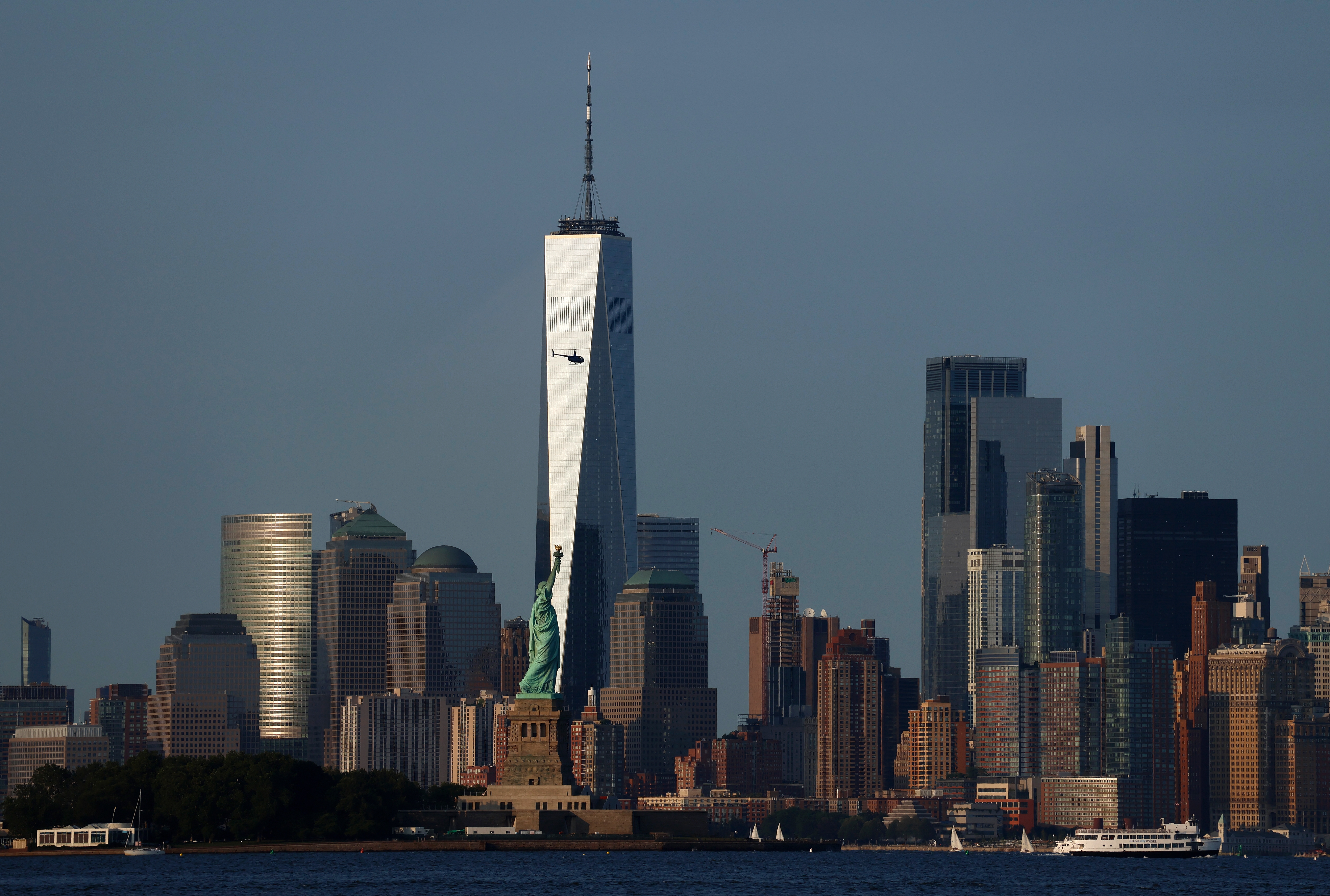 New York City skyline with One World Trade Center and the Statue of Liberty in the foreground