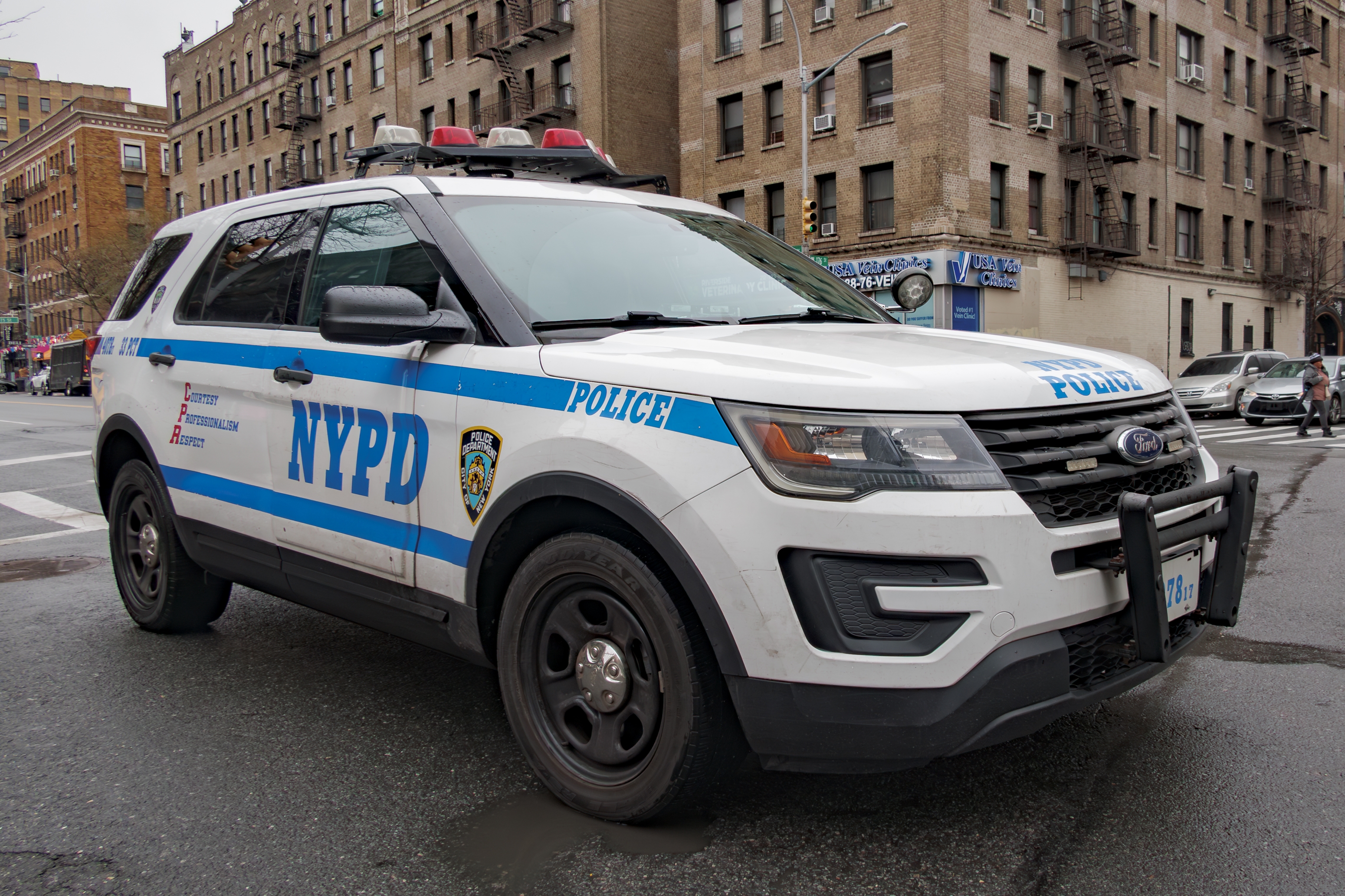 NYPD police SUV parked on a city street with buildings in the background
