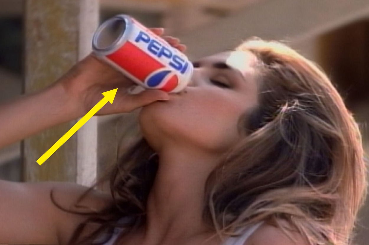 Person drinking from a Pepsi can, with long hair styled loosely