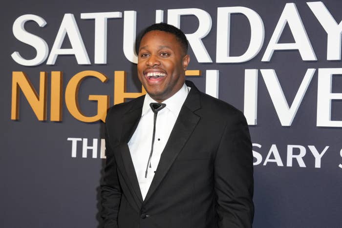 Person successful a tuxedo smiling astatine a "Saturday Night Live" lawsuit backdrop