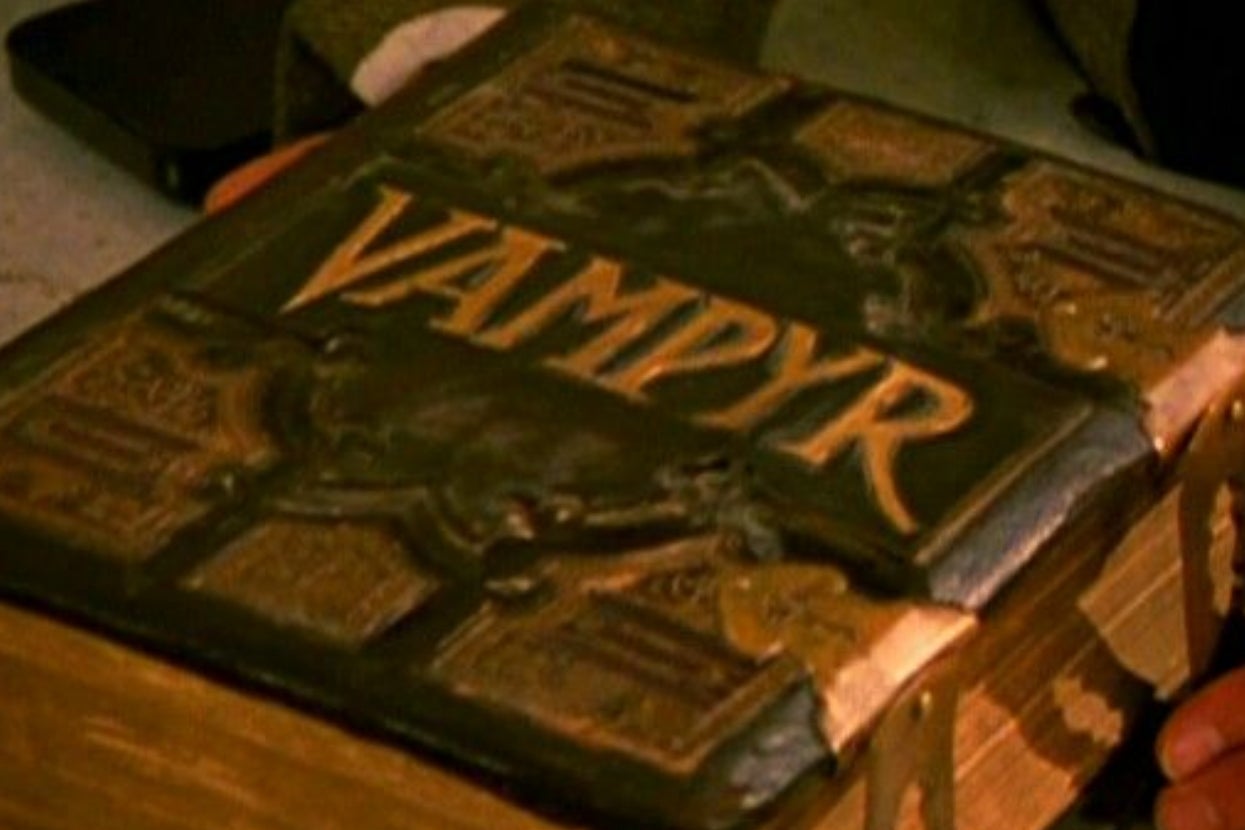 Close-up of an ornate book titled "Vampyr," with intricate detailing on its cover
