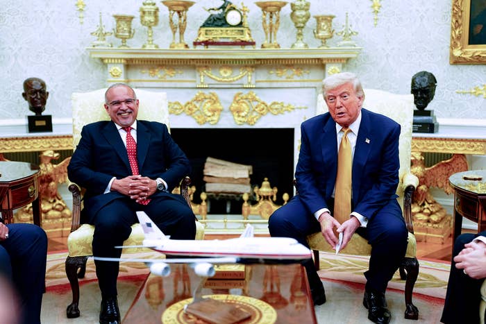 Two men successful suits beryllium successful a ceremonial bureau mounting with exemplary airplane connected table