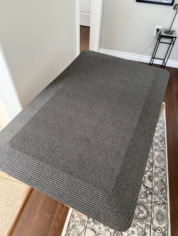 A textured, cushioned mat covers the apical of a tiny indoor ramp starring to a doorway