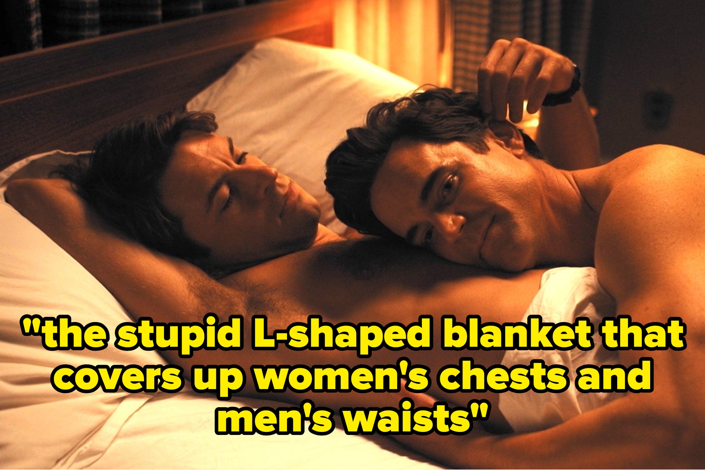 Two men lie in bed together, one resting his head on the other's chest, both appear relaxed and content