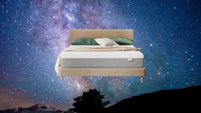 A furniture with a plush mattress and pillows is acceptable against a starry nighttime entity backdrop