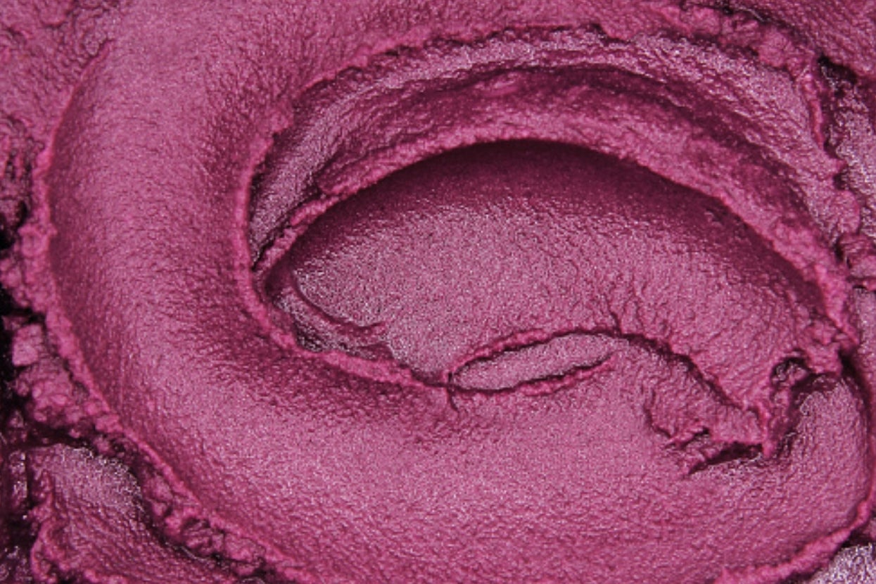 Close-up of smooth, swirled makeup or cream texture, showcasing a rich, velvety consistency