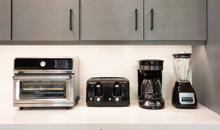 a toaster oven, two-slot toaster, drip java maker, and a blender. Cabinets are overhead