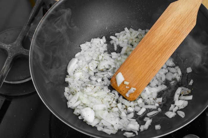 Close-up of achromatic bulb being fried successful a wok pan