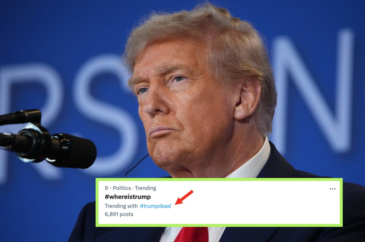 Donald Trump in a suit and red tie speaks into a microphone during an event