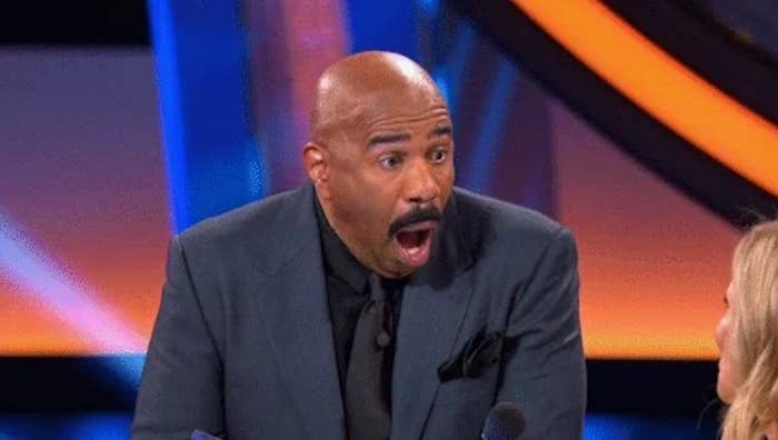 Host reacts with astonishment during a crippled amusement moment, rima unfastened and wide-eyed, engaging with a contestant