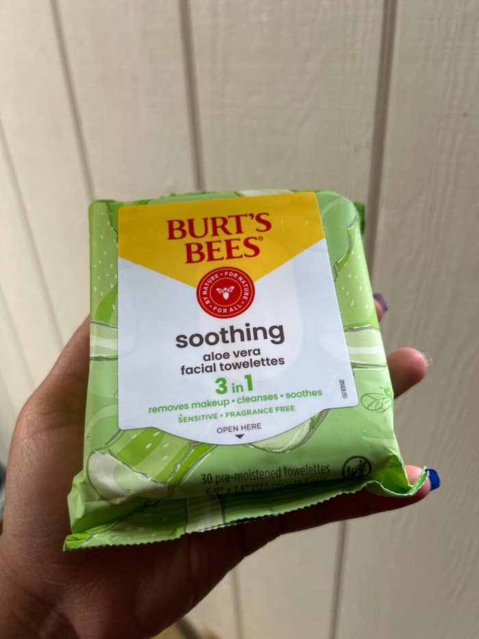 Person holding a battalion of Burt's Bees soothing aloe vera facial towelettes, labeled arsenic 3-in-1: removes makeup, cleanses, and soothes