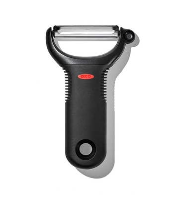 Vegetable peeler with a stainless alloy leaf and ergonomic achromatic handle, suitable for assorted peeling tasks successful the kitchen