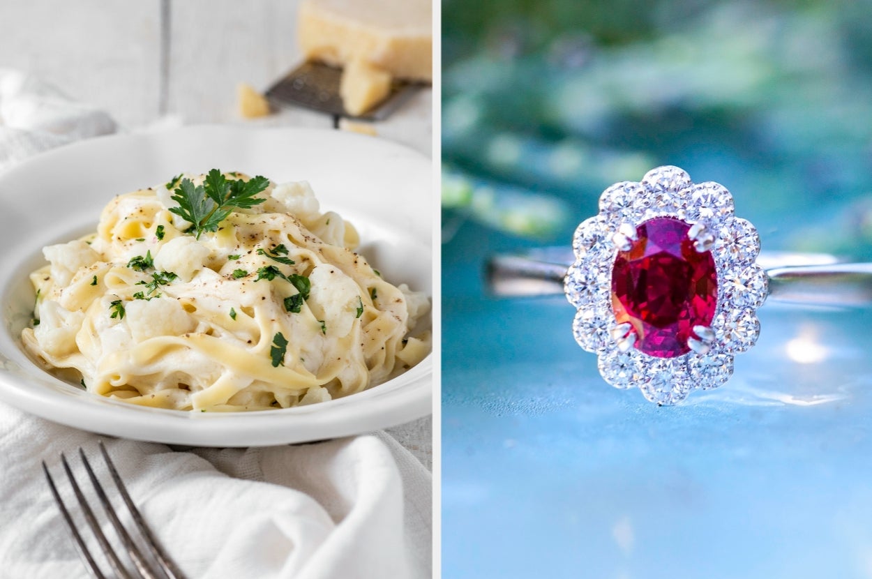 A plate of creamy pasta garnished with parsley alongside a sparkling ring with a red center stone and a halo of clear stones