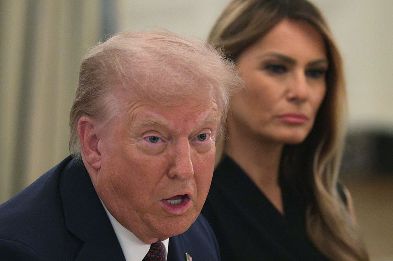 I don't know who these people are, but the image shows a man and a woman sitting at a table, both dressed formally. The man appears to be speaking