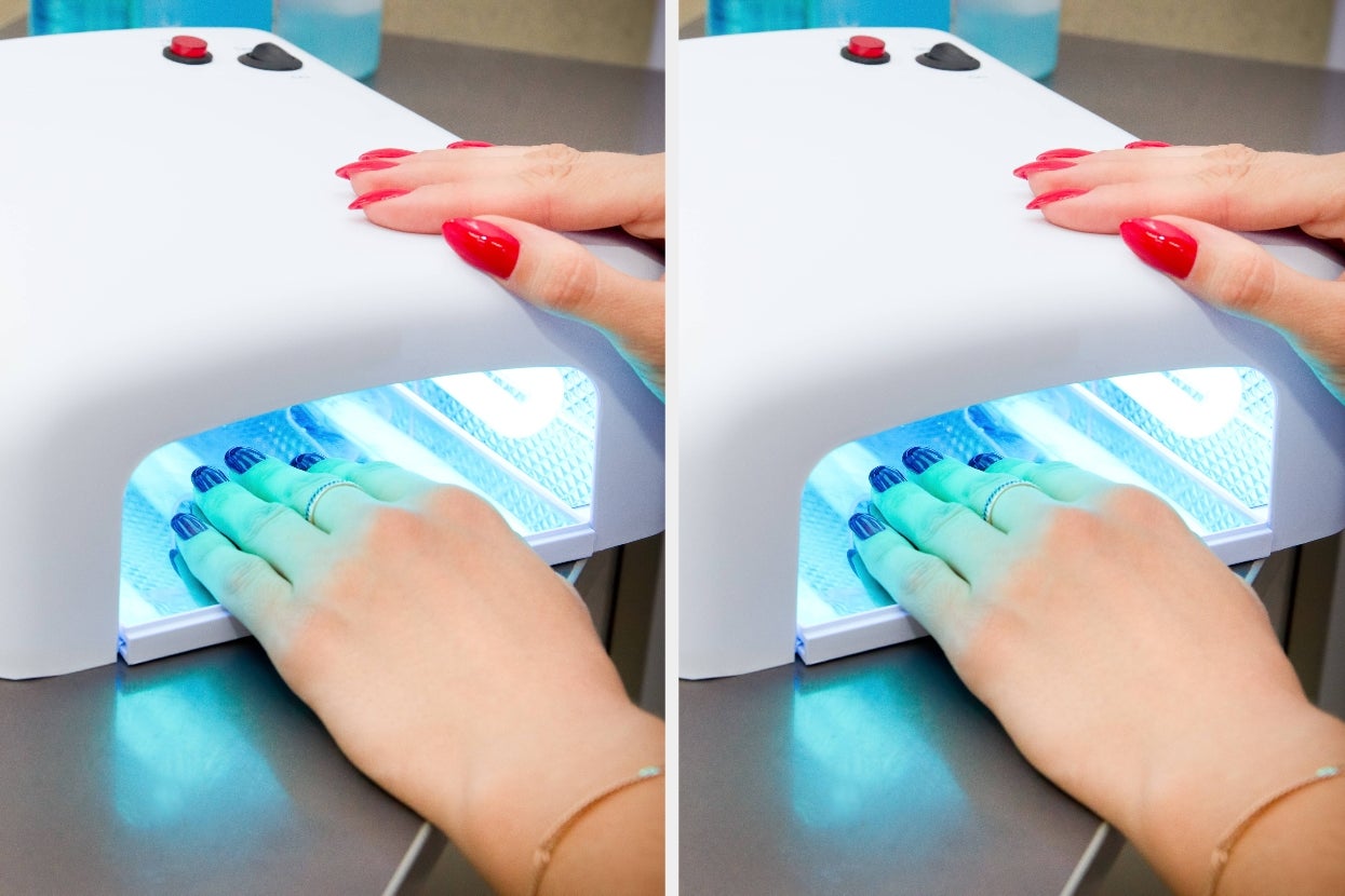 Hands with red and blue nail polish under UV lamps for a manicure, showing gel drying process