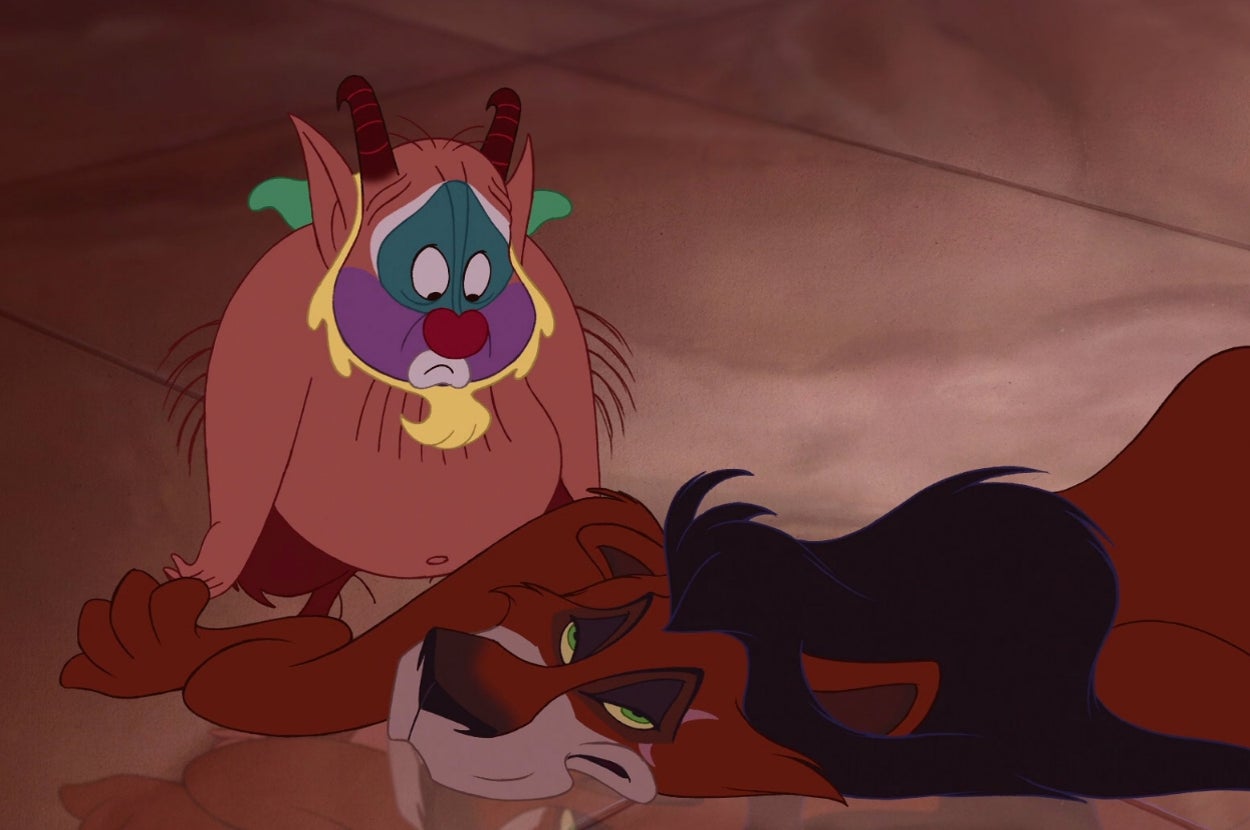 Animated characters: a tired lion with a dark mane lies down, while a small, concerned creature with horns and colorful face looks on