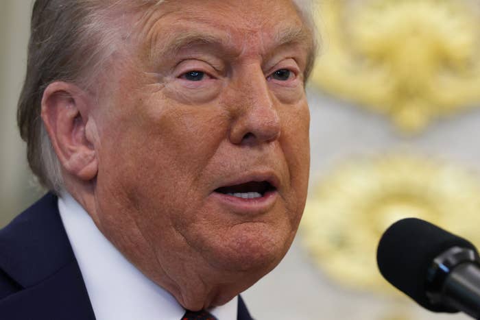 Donald Trump speaking astatine a microphone, appearing successful a ceremonial setting, perchance delivering a code oregon statement
