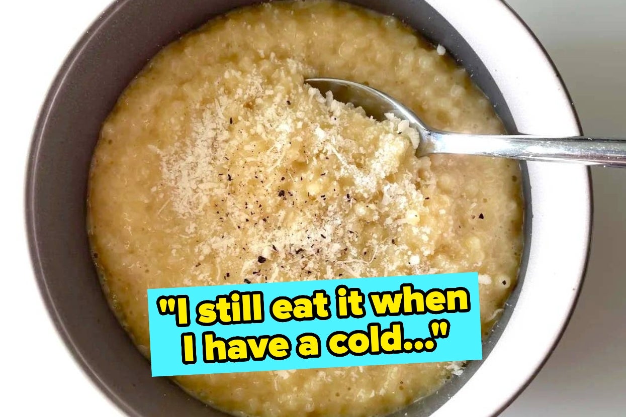Bowl of grits topped with cheese and pepper, next to a spoon. Text overlay: "I still eat it when I have a cold..."