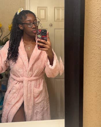 Person successful a bath reflector selfie wearing a fluffy bathrobe and glasses, posing with hairsbreadth tied back