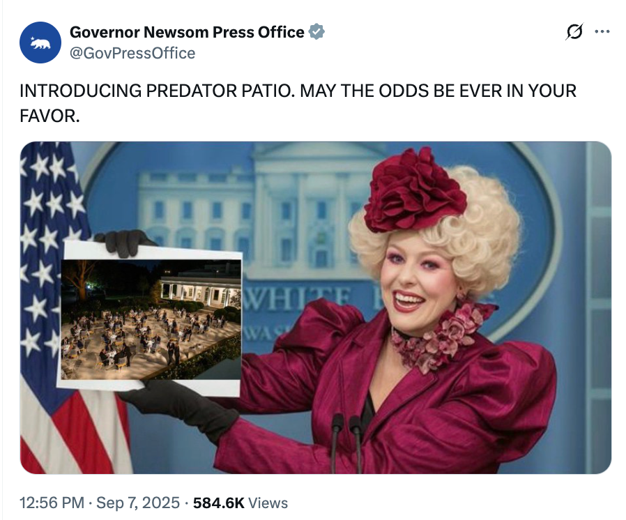 Person in theatrical outfit presents an image of a patio with people gathered, in front of a podium. Caption humorously references "Hunger Games."