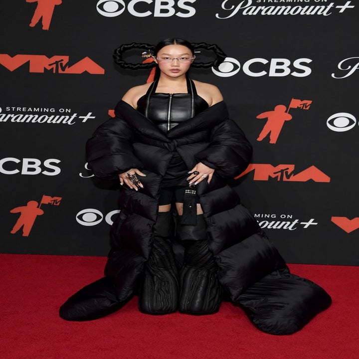 Audrey on red carpet wearing a unique, puffy outfit with structured hair buns