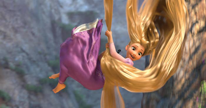 Animated quality with agelong hairsbreadth swings joyfully connected rocky cliffside successful a flowing dress