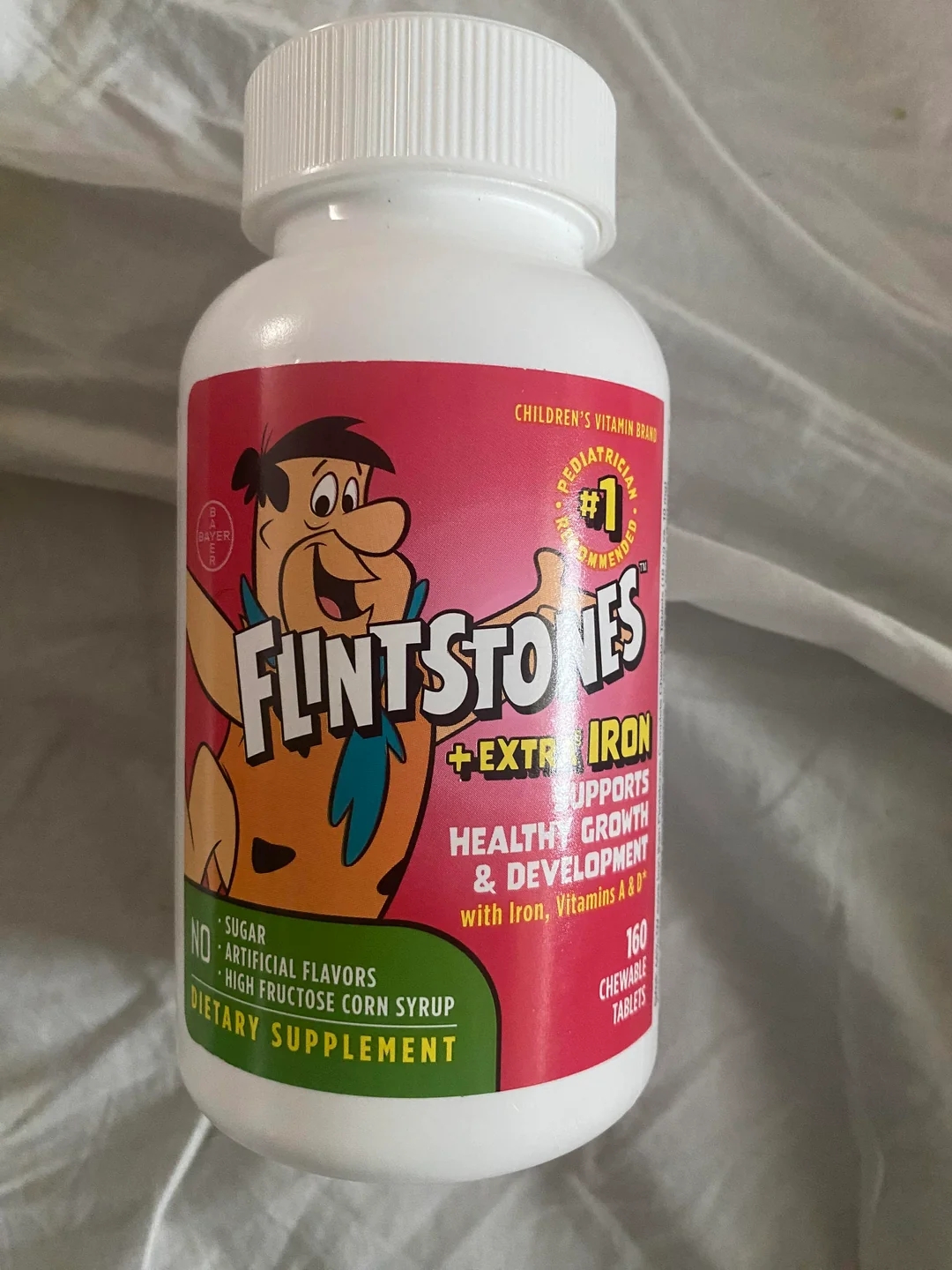 En flaske flintstones tyggbare vitaminer, merket som ekstra jern, som støtter sunn vekst og utvikling med jern, vitamin A og E