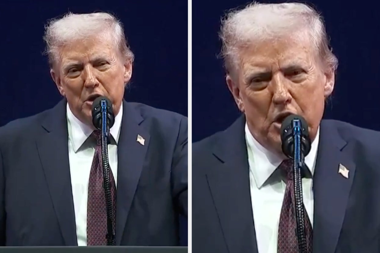 A person in a suit is speaking at a podium, emphasizing a point. The setting suggests a formal event or speech