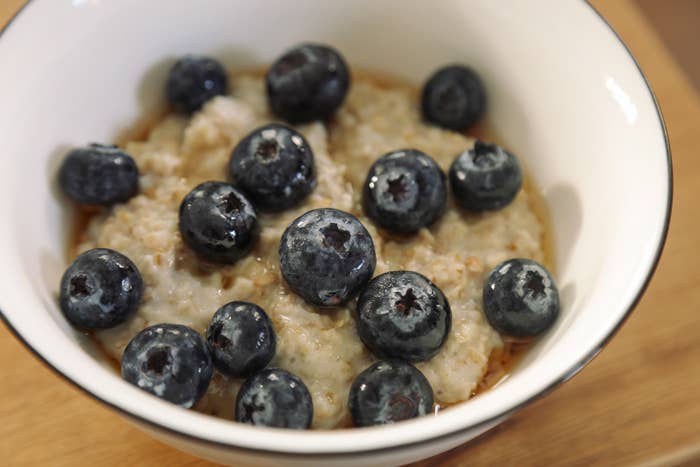 Bowl of oatmeal topped with caller blueberries