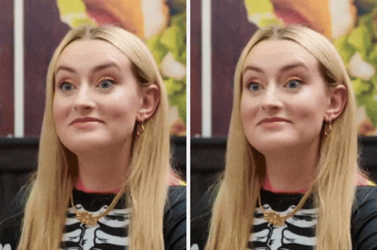 Person reacting with a surprised expression, smiling, sitting indoors
