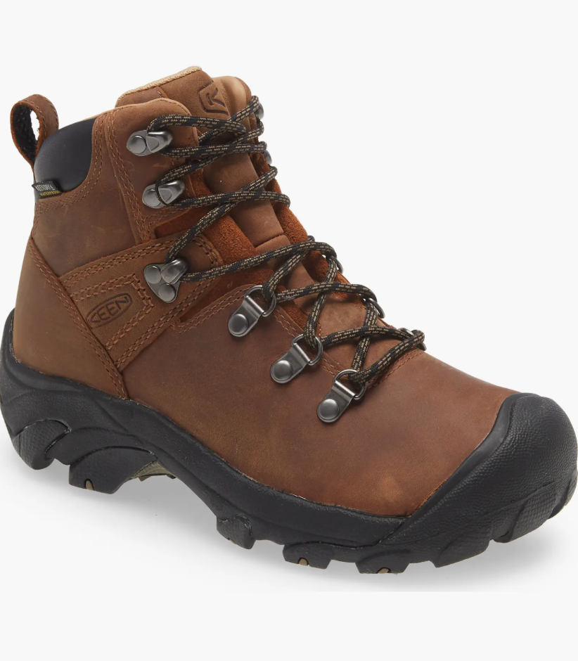 Brown leather hiking boot with rugged outsole and metal eyelets for laces, suitable for outdoor activities