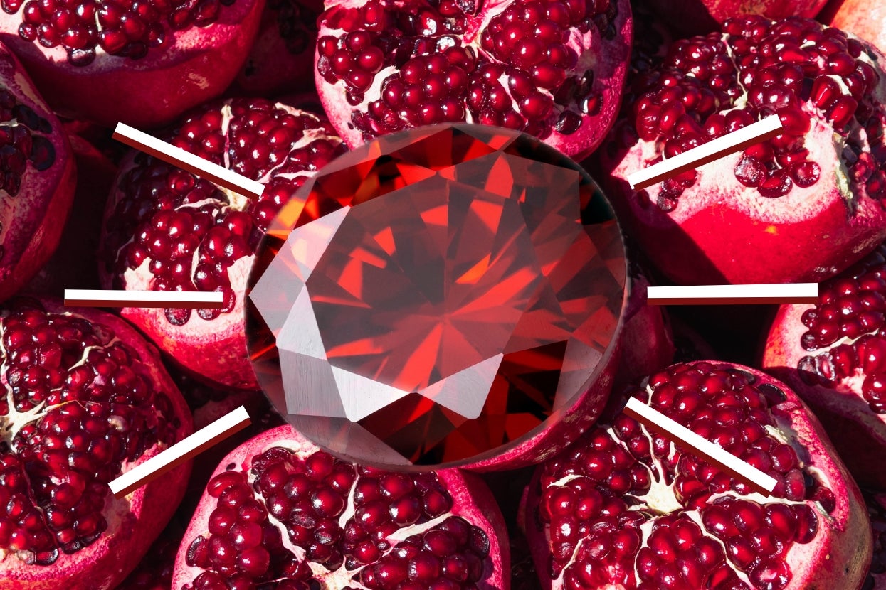 A large, multifaceted gemstone is centered among halved pomegranates, highlighted with white lines pointing towards it