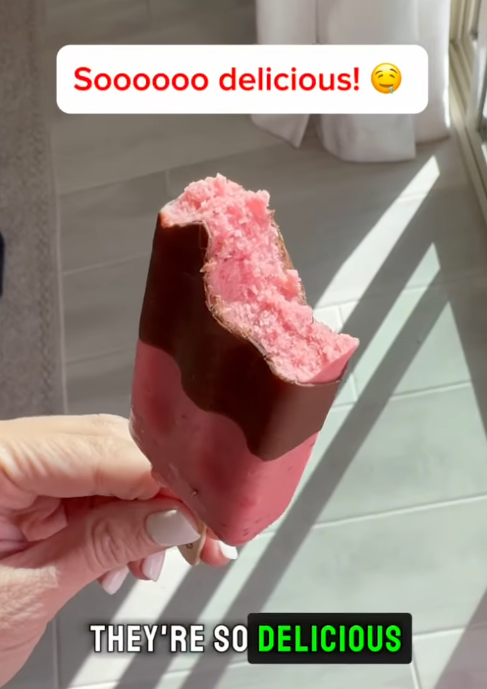 A hand holds a partially eaten ice cream bar with a chocolate coating. Text reads: "Soooooo delicious!" and "They're so delicious."