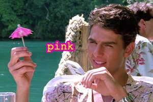 A person holding a small cocktail umbrella outdoors, with "pink" written beside it