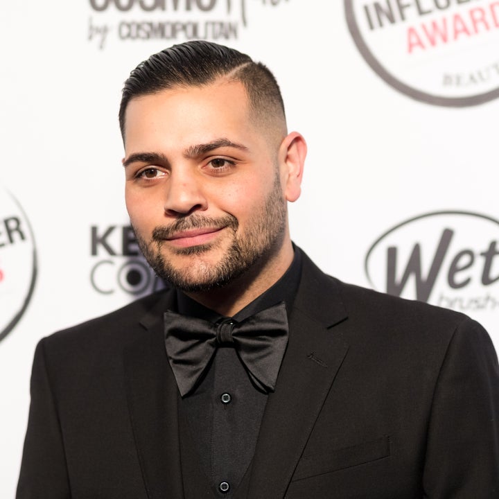 A person wearing a formal black suit and bow tie at the American Influencer Awards