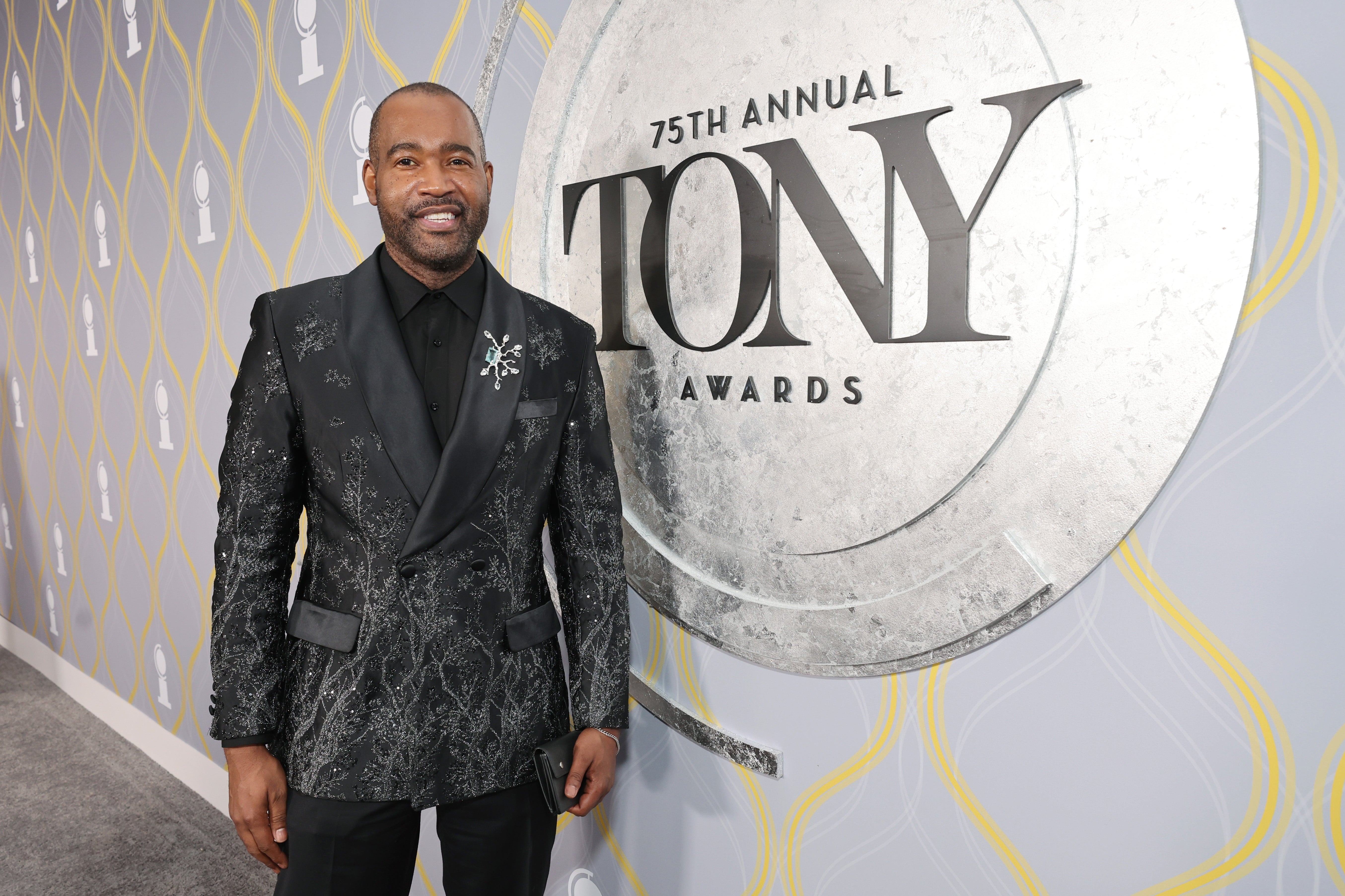 Man in a floral patterned tuxedo poses at the 75th Annual Tony Awards
