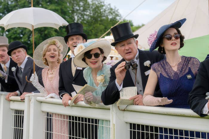 People successful vintage ceremonial attire with hats and gloves observe an lawsuit outdoors