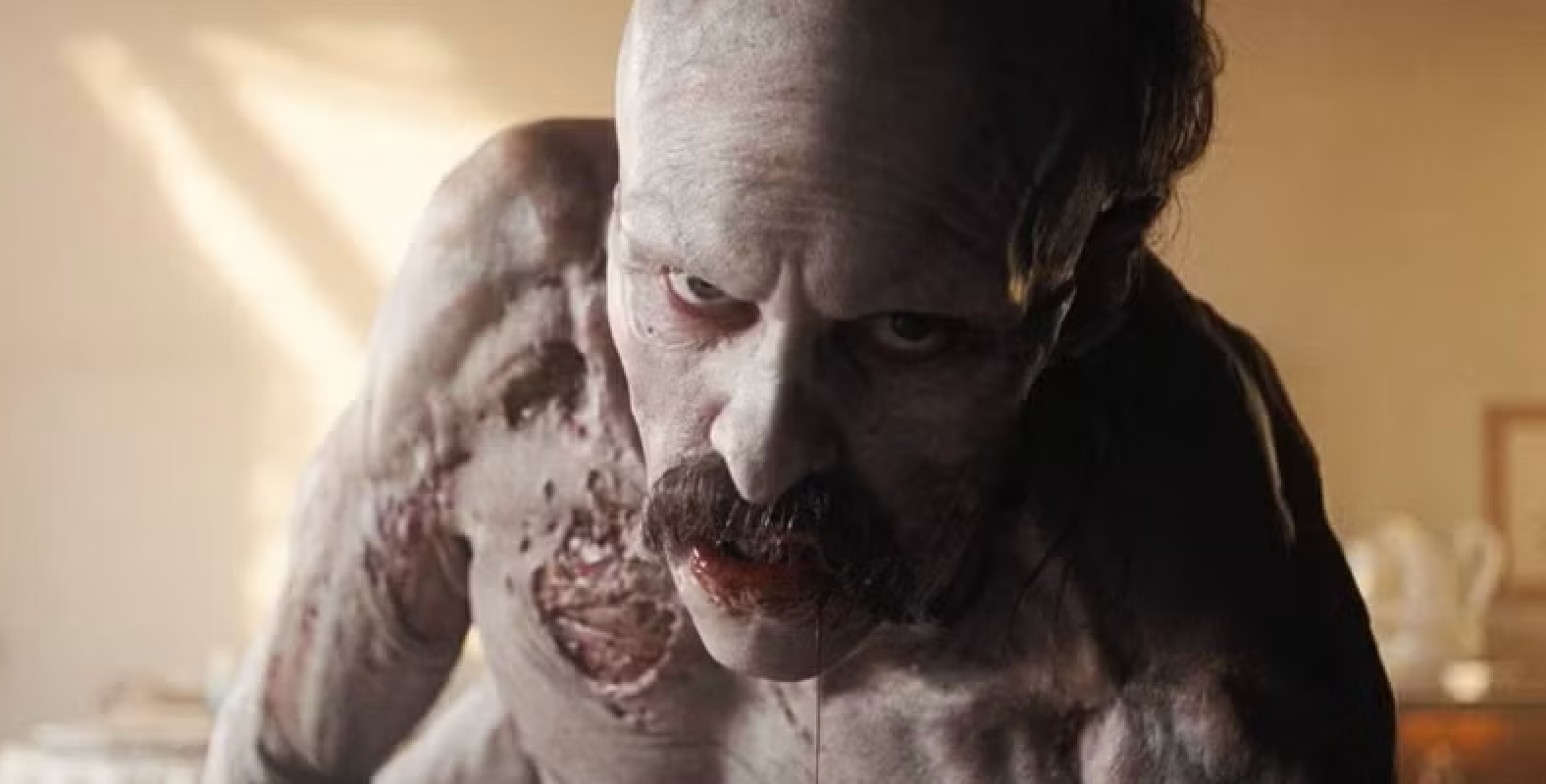 A zombie-like quality  with decayed tegument  and a mustache leans guardant  menacingly, evoking a fearfulness   theme, suitable for a TV oregon  movie   scene