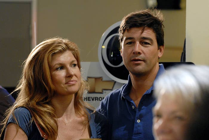 Two actors basal together, attending an event. The antheral wears a casual shirt, and the pistillate has escaped hair, wearing a elemental top. They're successful a candid moment