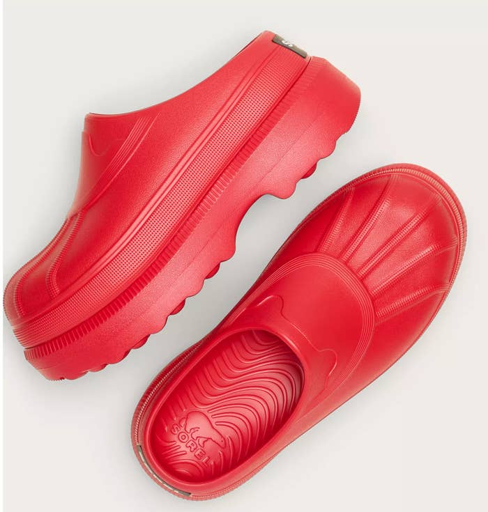 Red slip-on clogs with a textured sole and a sleek, streamlined design